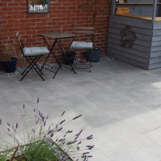 Dusk Grey Porcelain Patio Paving with seating and Outdoor Bar