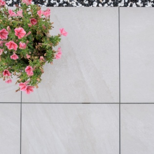 Vitripiazza Anno Lite Grey Porcelain Patio with contrasting plant